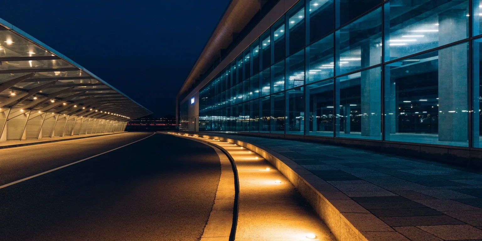 Sydney Airport terminal precinct at night with glowing lights